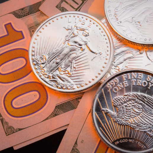 One ounce .999 fine silver rounds resting on $100 bills