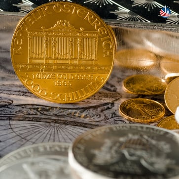 Gold Philharmonic sitting among silver coins and bars