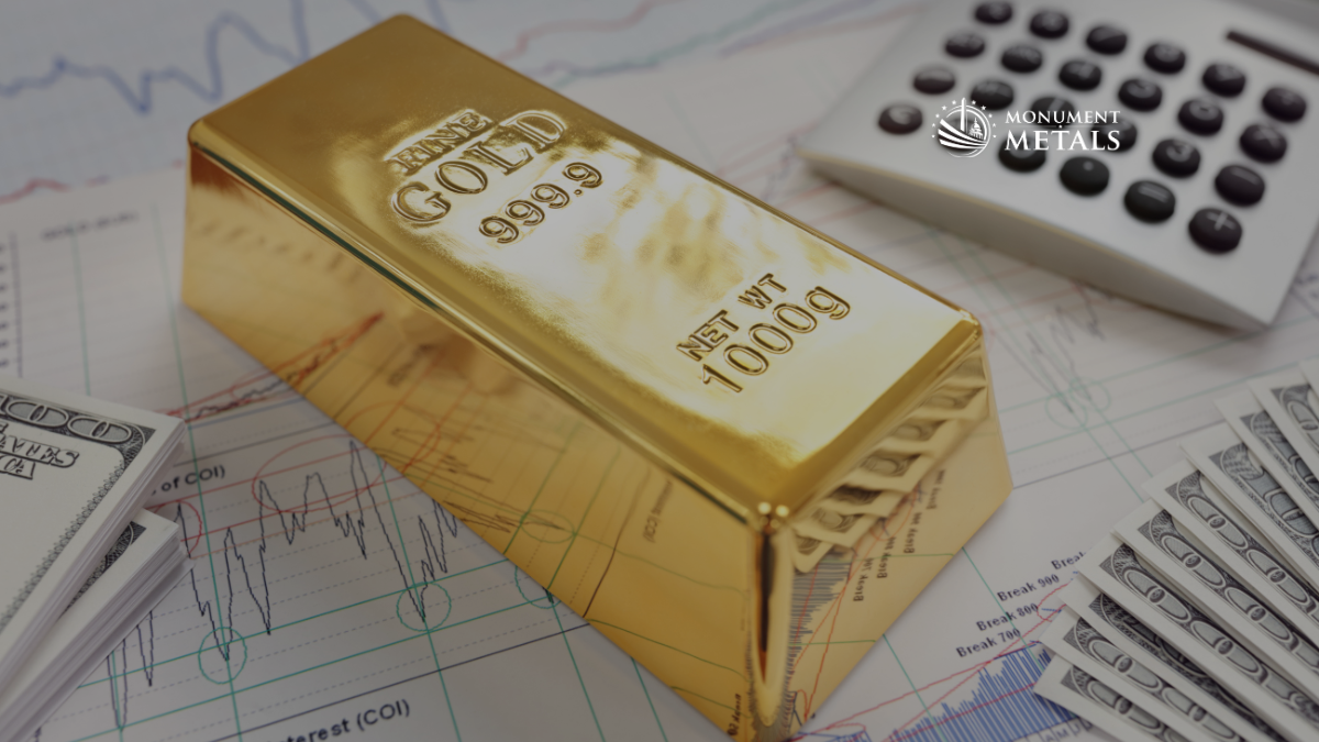 1 kilogram gold bar resting on financial charts with U.S. dollar bills and a calculator, illustrating the relationship between gold prices, inflation, and economic analysis.