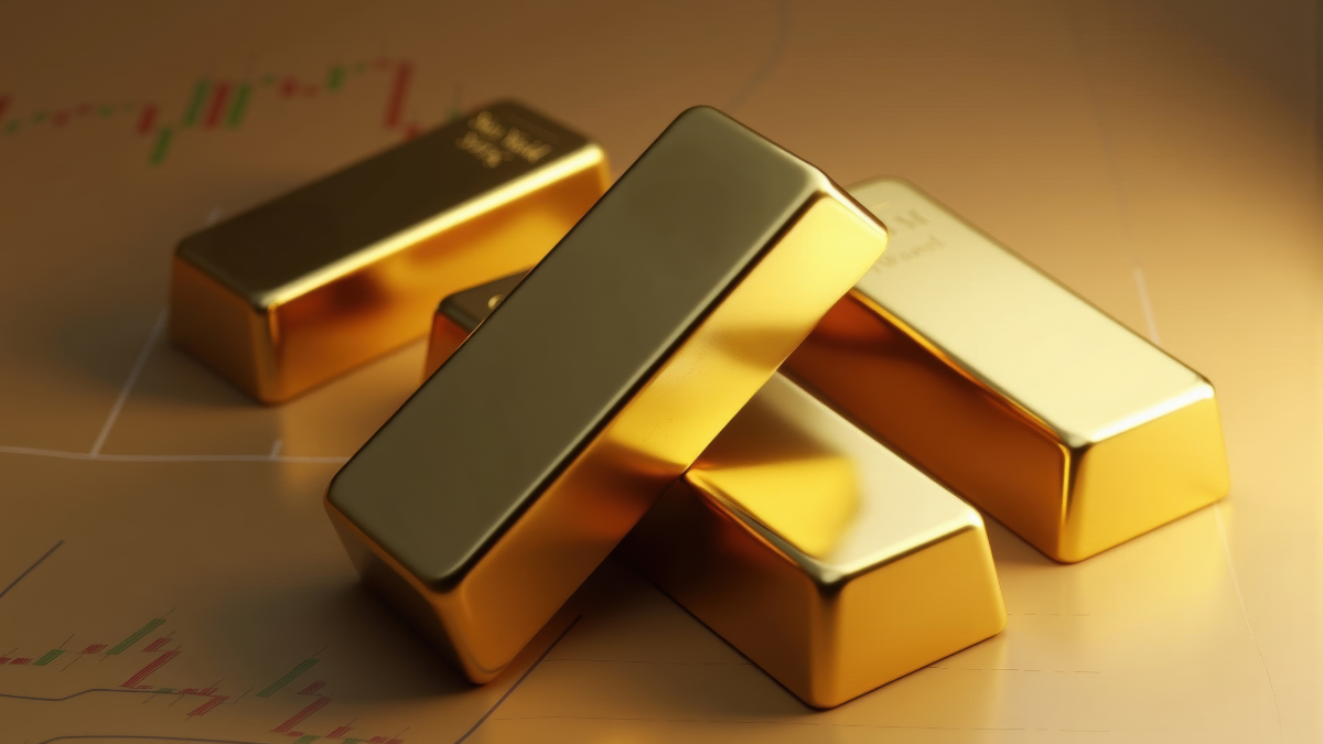 Stacked gold bars resting on a financial chart background representing gold prices and market trends.