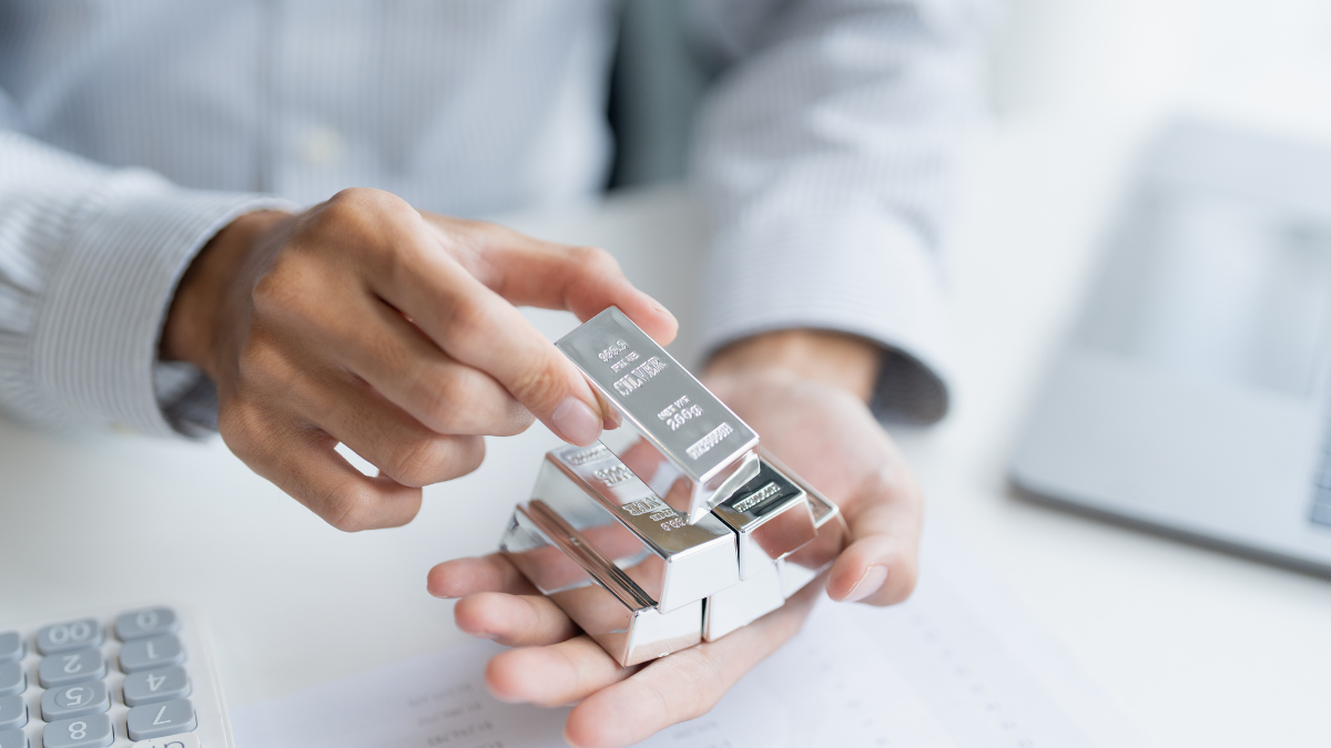 Person Holding Silver Bars