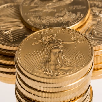 Close-up of American Gold Eagle coins featuring Lady Liberty design, detailed engraving, and stacked presentation, symbolizing trusted U.S. gold bullion.