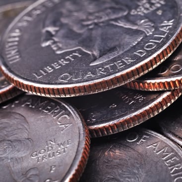 Stack of circulated US quarters with copper clad edges visible showing reeded rims and Liberty inscription