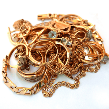 Tangled pile of gold chains, bracelets, and rings to sell at a Frederick gold buyer