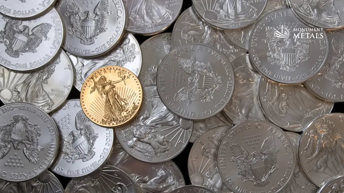 American Silver Eagles in pile with one American Gold Eagle 
