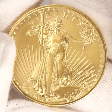 white glove holding an american gold eagle
