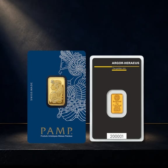 PAMP Suisse gold bar in blue assay packaging displayed on a dark stone surface.